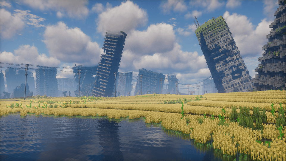 Champs jaunes de seawheat devant des immeubles penchés dans Tideworn sur Minecraft.