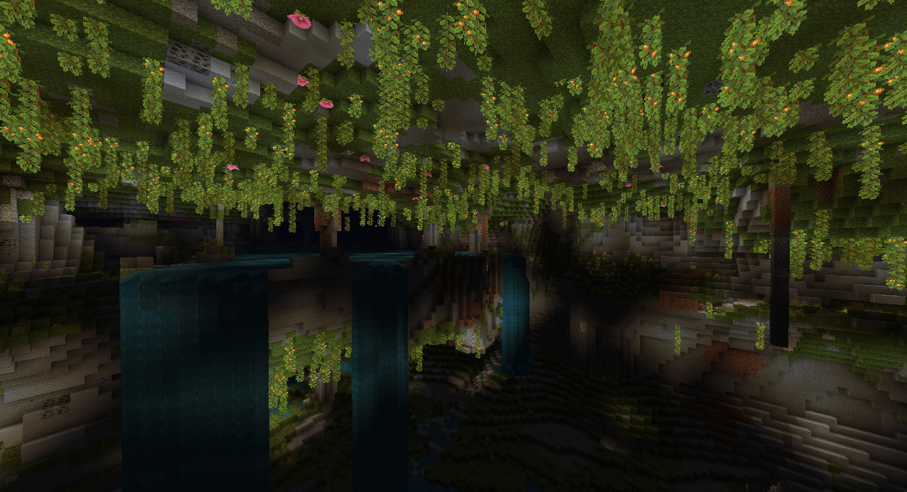 Grande caverne luxuriante de Minecraft avec mousse, cascades, lianes et végétation souterraine.