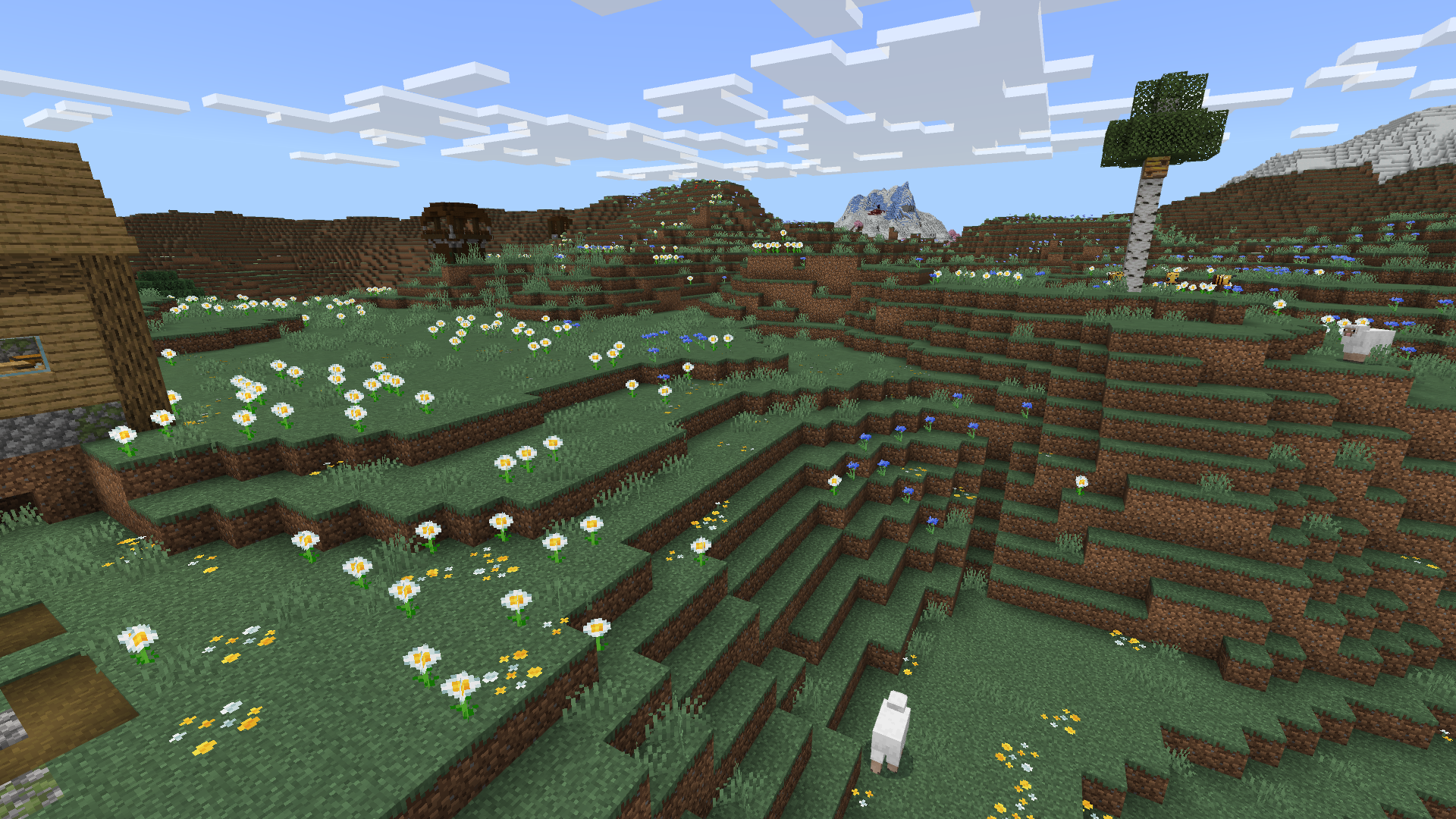 Prairie de Minecraft sur un plateau de montagne couvert d’herbe et de fleurs.