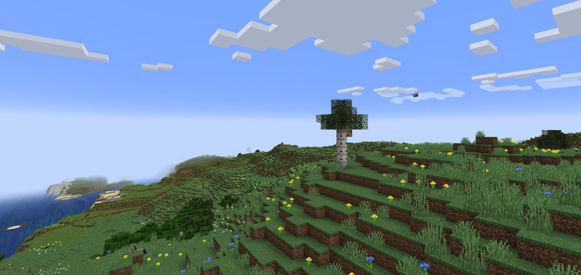 Prairie de Minecraft avec des fleurs sauvages, des moutons et des ânes.