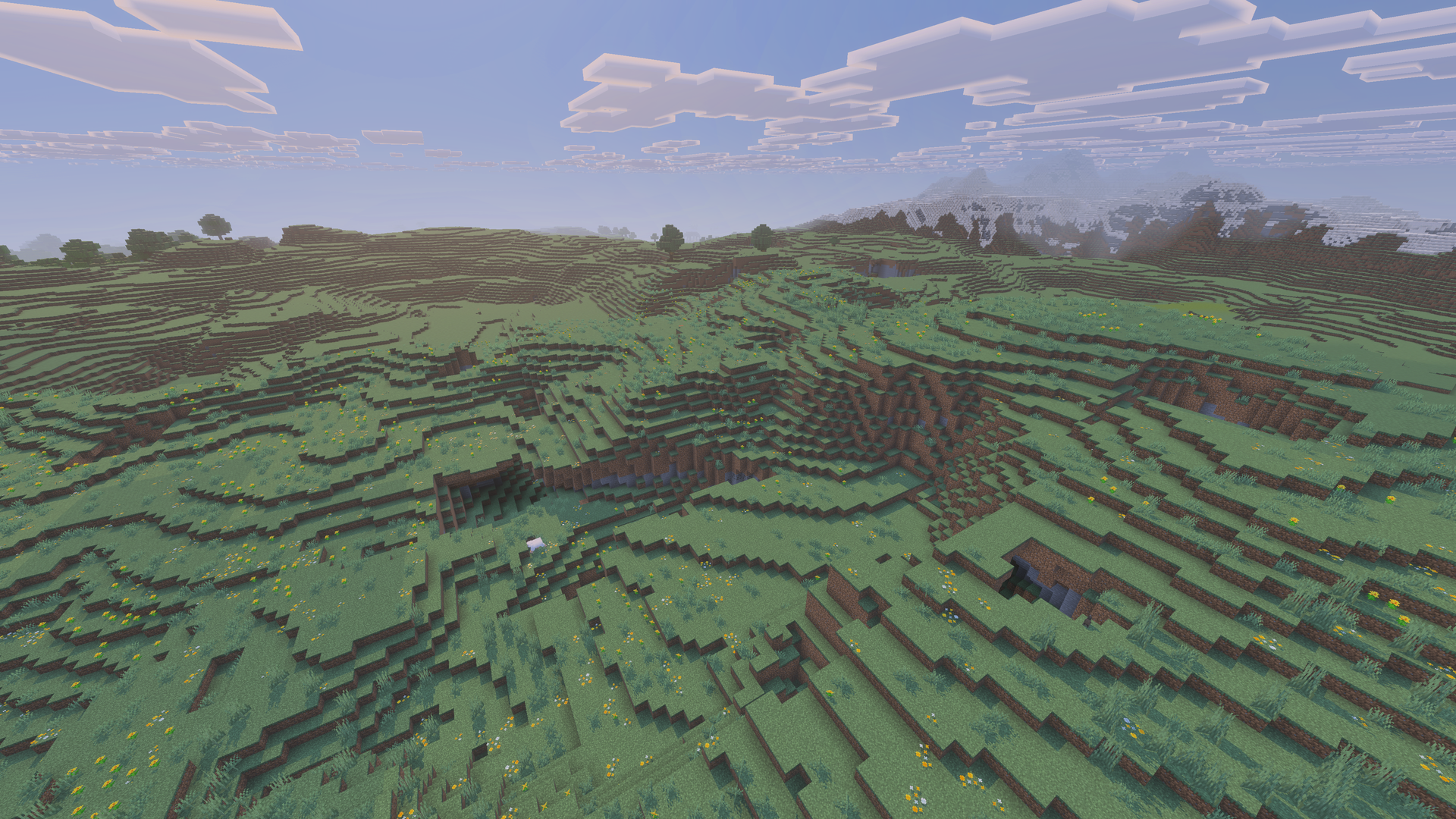 Grande Prairie de Minecraft formant un plateau herbeux entre plusieurs montagnes.
