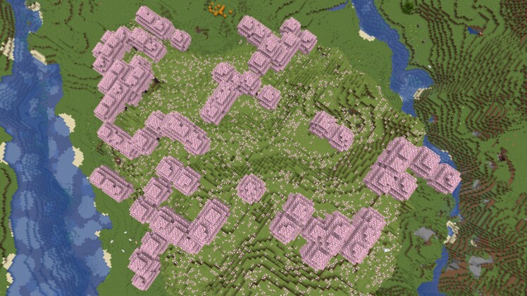 Vue aérienne d’un Bosquet de cerisiers au milieu des montagnes dans Minecraft.