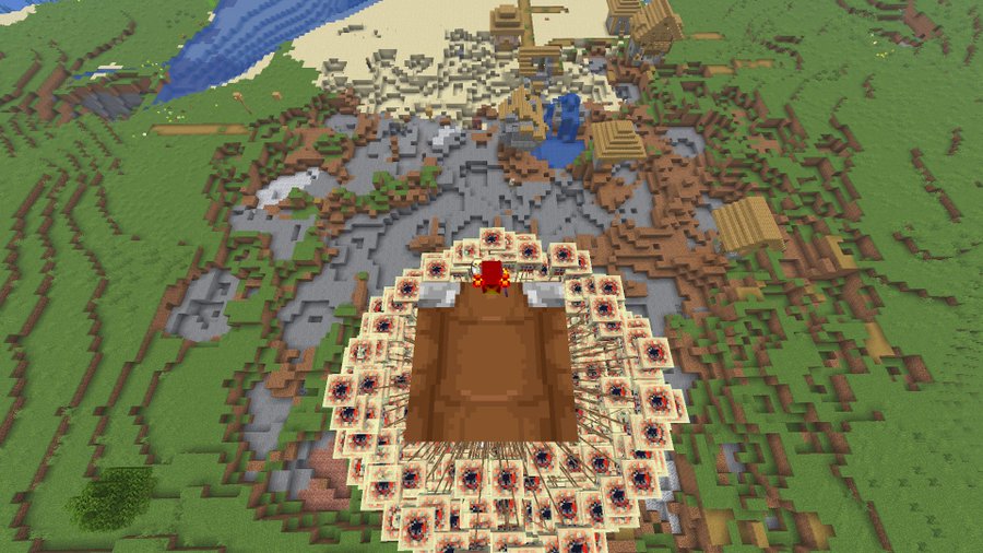Plusieurs cubes de soufre avec TNT suspendus par des laisses sous un Happy Ghast dans Minecraft