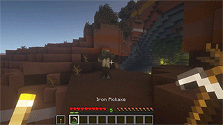 Un joueur Minecraft attaque un mob avec un outil tout en tenant une torche en main secondaire avec Torch hit!