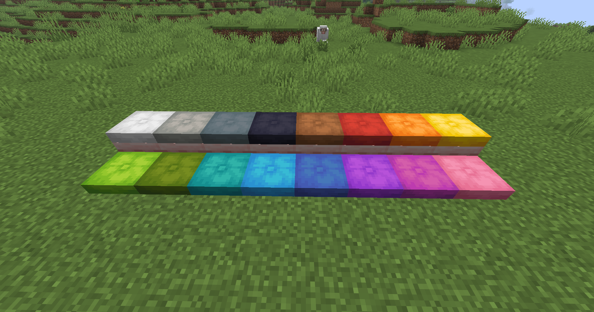 Les 16 couleurs de coussins dans Minecraft Les 16 couleurs de coussins alignées sur l’herbe dans Minecraft