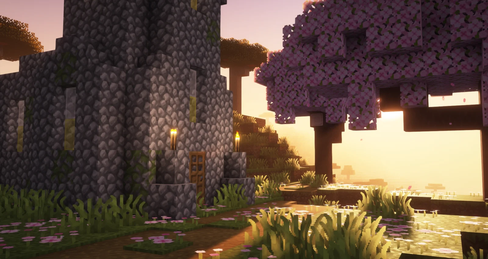 Smooth Craft dans l'Overworld Maison en pierre entourée de végétation et d'un cerisier avec Smooth Craft